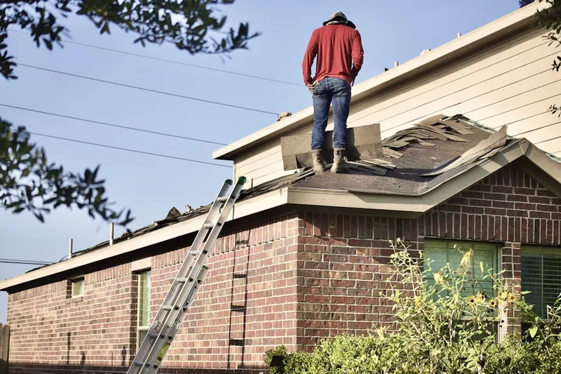 Professional roofer working on a residential roof in McDonough